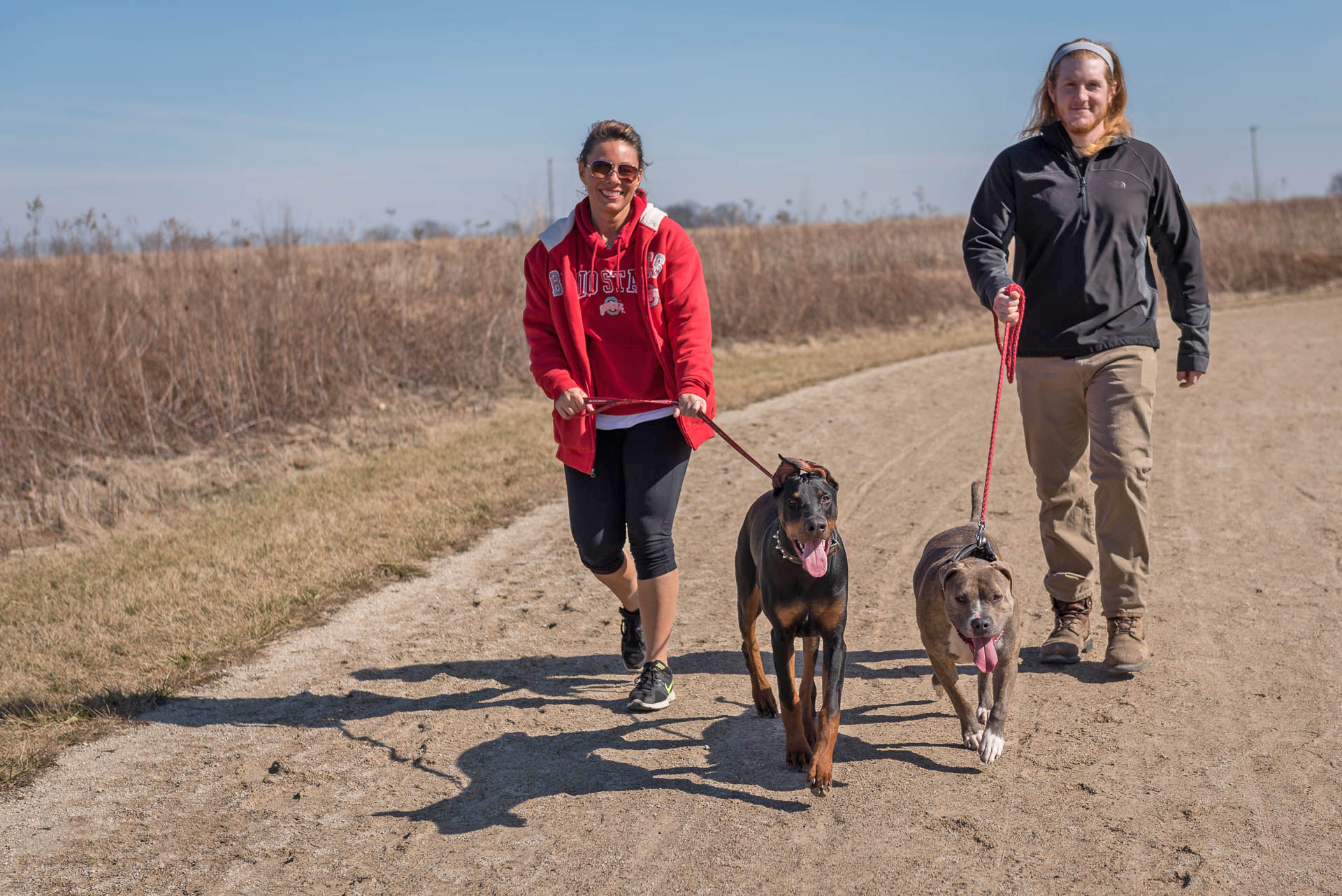 People walk their dogs on the Darby Creek Greenway Trail at Battelle Darby Creek. Photo by John Nixon.