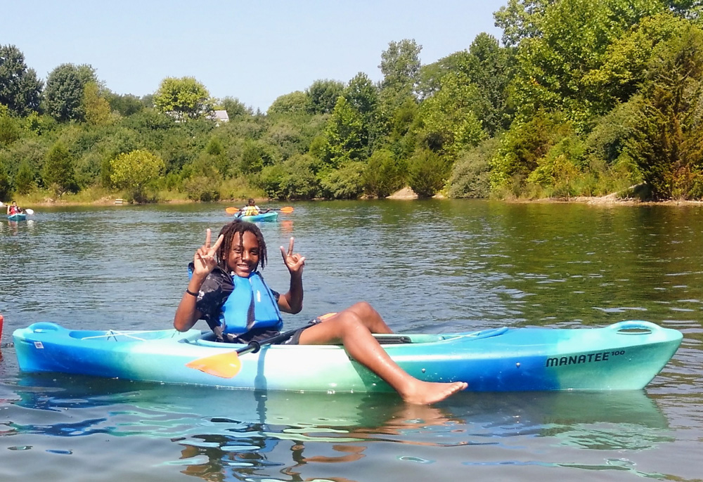 A child poses in a kayak at an Outdoor Adventure program at Scioto Grove Metro Park.