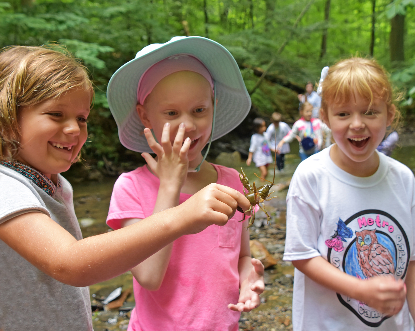 Girls find a crayfish at a nature camps at Highbanks.