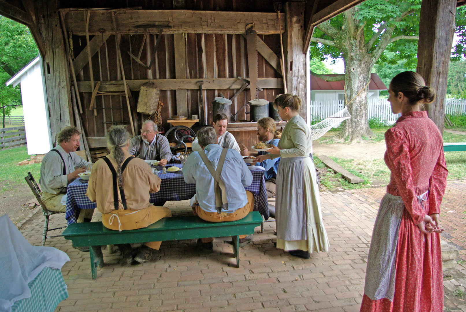 Farm staff enjoy lunch in the eaves of the summer kitchen. (Frank Kozarich)
