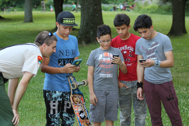 Blendon Woods Ranger Brandon Novotny with kids searching for Pokémon.