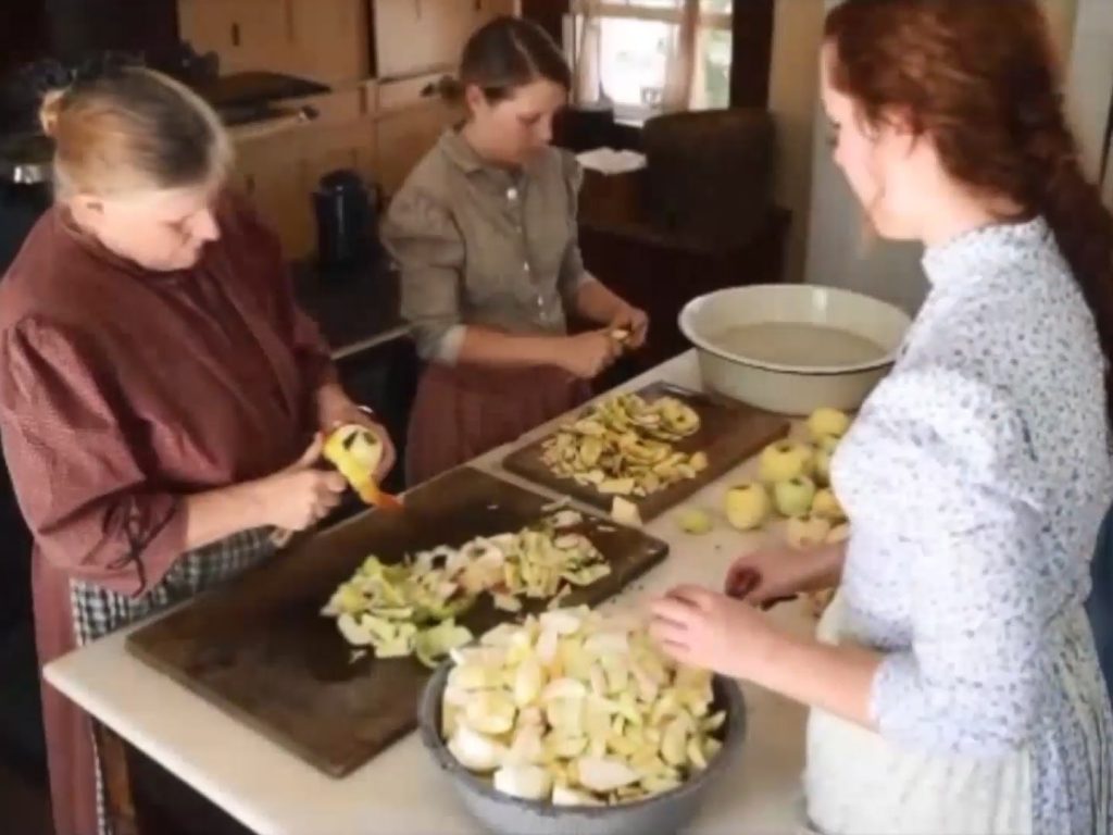 Volunteers at Slate Run Living Historical Farm peel and slice apples for making apple butter and cider