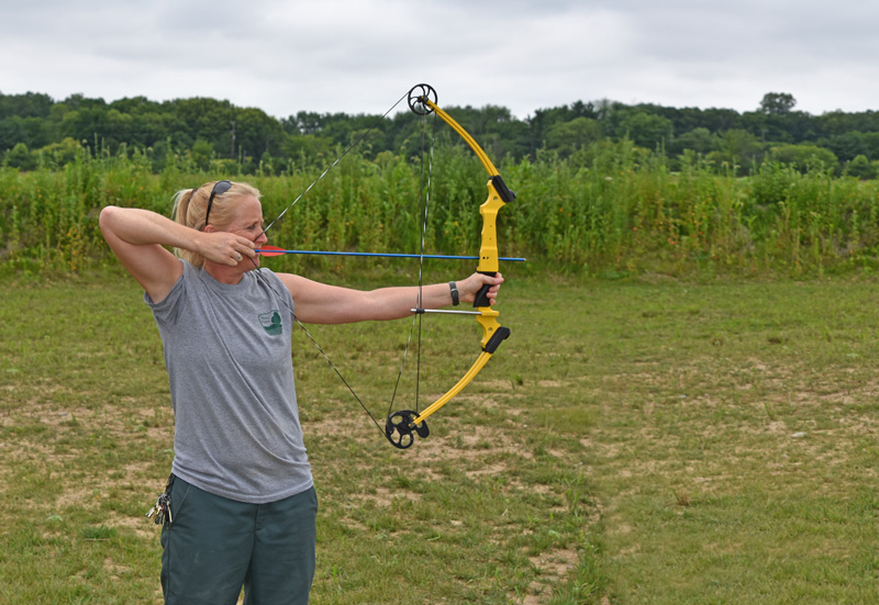 Scioto Grove Assistant Manager Robin Blair uses a compound bow at the static archery course.