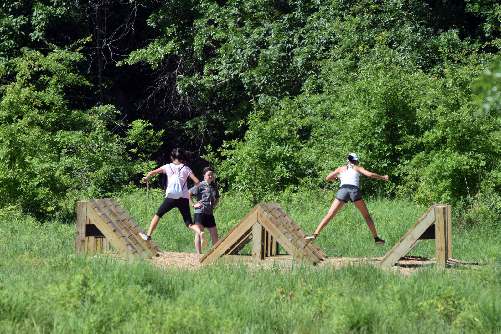 Visitors take on the frog hop on the Challenge Course at Glacier Ridge.