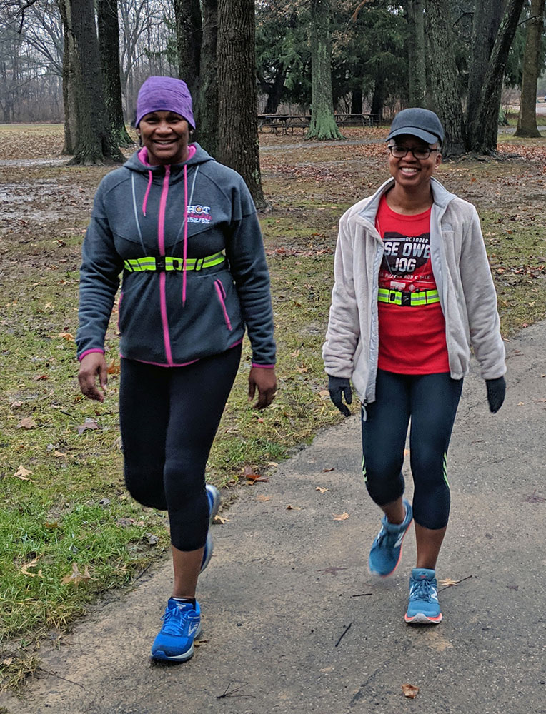 Two women walk toward the Beech Trail from Ash Grove parking lot at Blacklick Woods Metro Park.