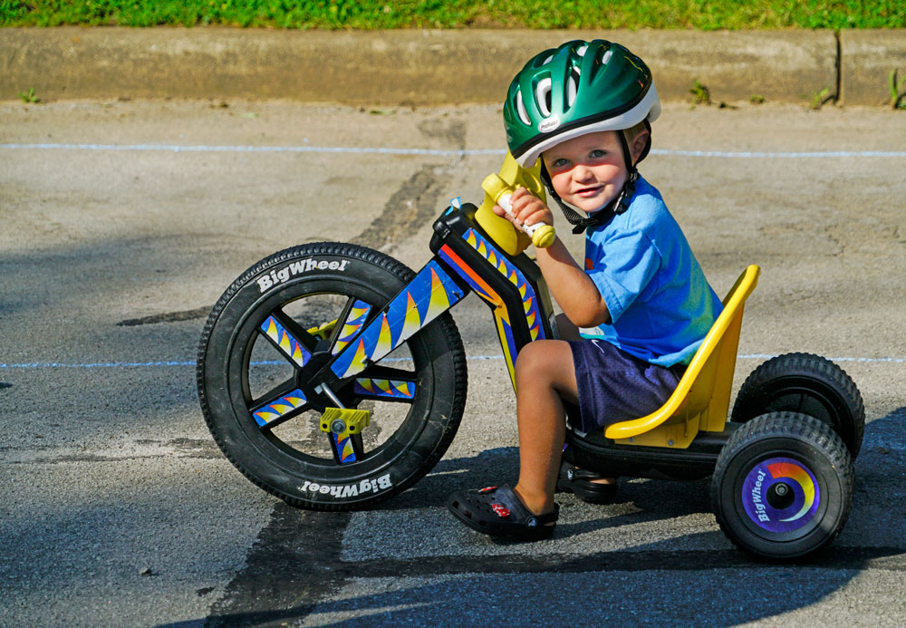 Youngster on the Big Wheel tri-bike at Highbanks' Outdoor Adventure.