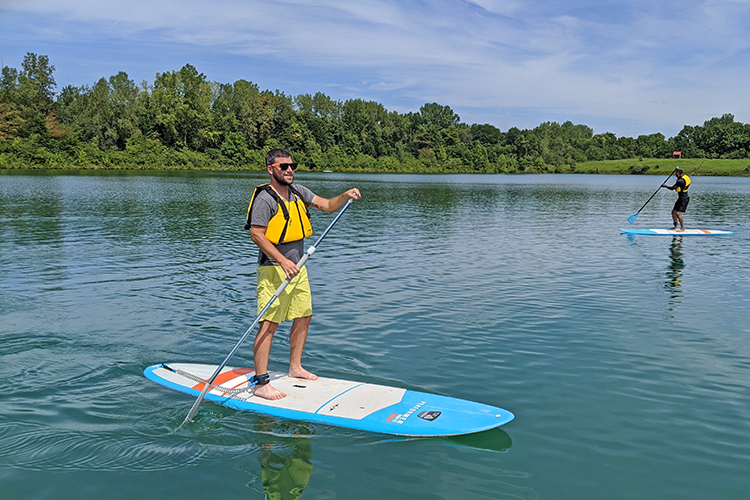 People paddleboard at Darby Bend Lakes at Prairie Oaks Metro Park