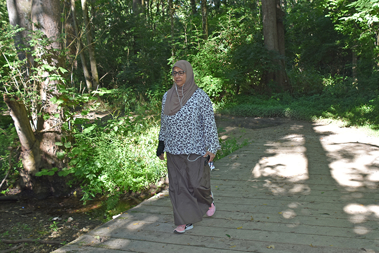 Woman walks on Alder Trail at Prairie Oaks Metro Park