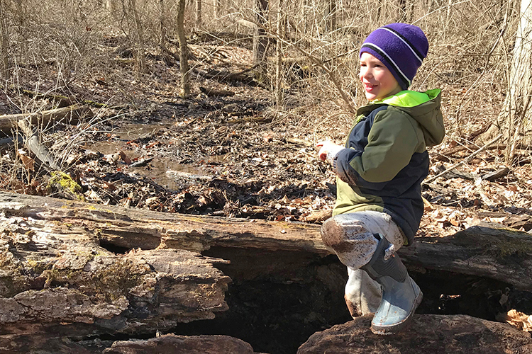 A child plays in the natural play area at Sharon Woods Metro Park