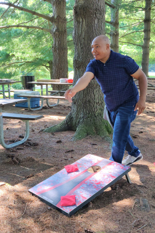 Man playing cornhole at Three Creeks Metro Park