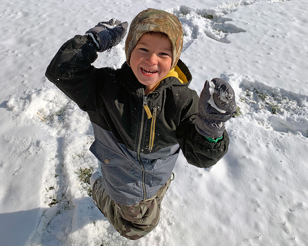  A kid gets ready to throw a snowball near the Multiuse Trail at Scioto Grove Metro Park. 