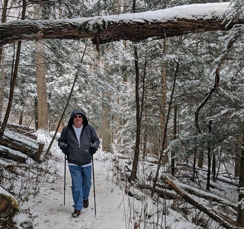 A man hikes on the Fern Trail during the winter hike at Clear Creek Metro Park.