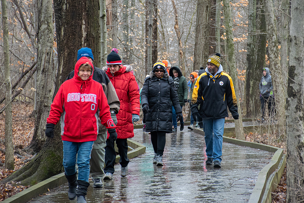 Visitors hiking on the Frog Talk Walk Trail at the winter hike at Inniswood Metro Gardens.