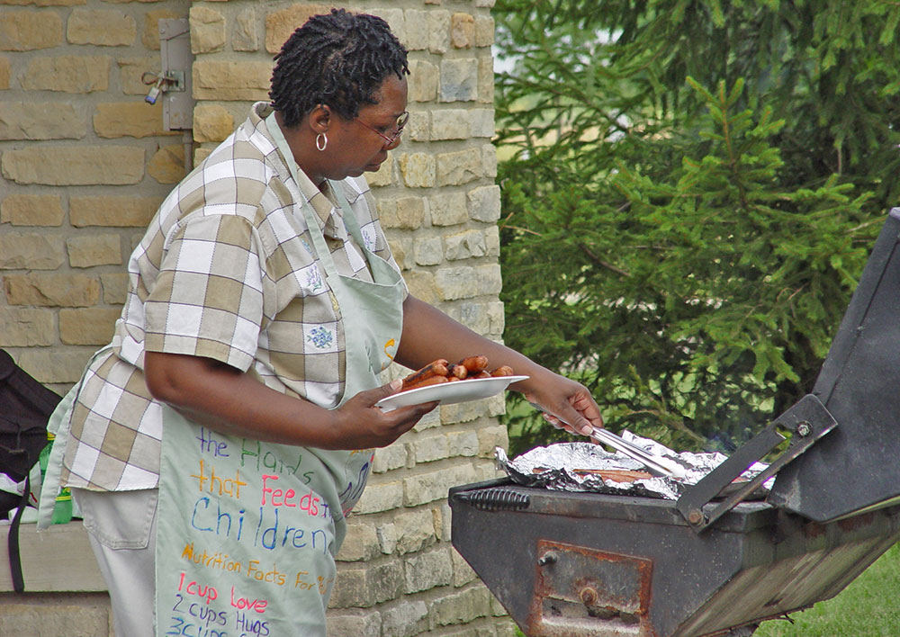 Visitor grilling hot dogs at Homestead's Pine Pavilion.