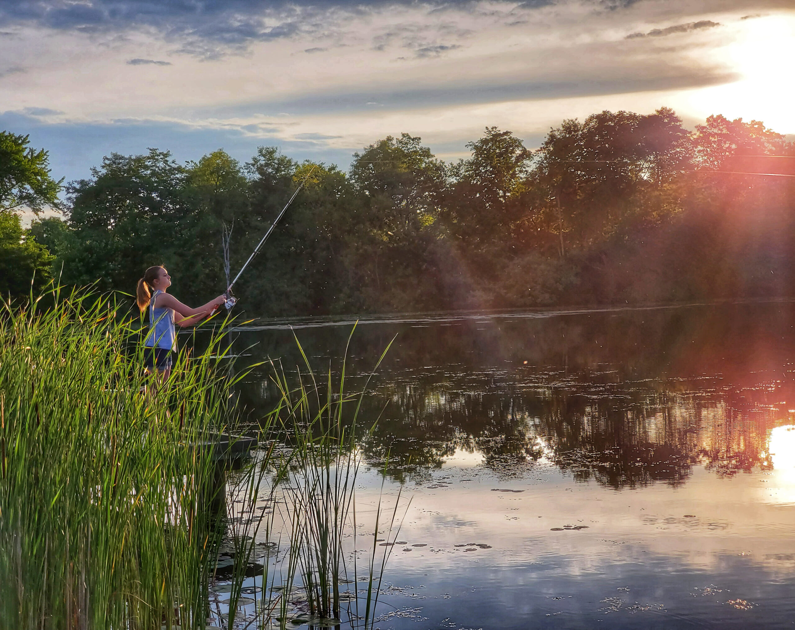 A woman fishing at Buzzards Roost Lake at Slate Run Metro Park.