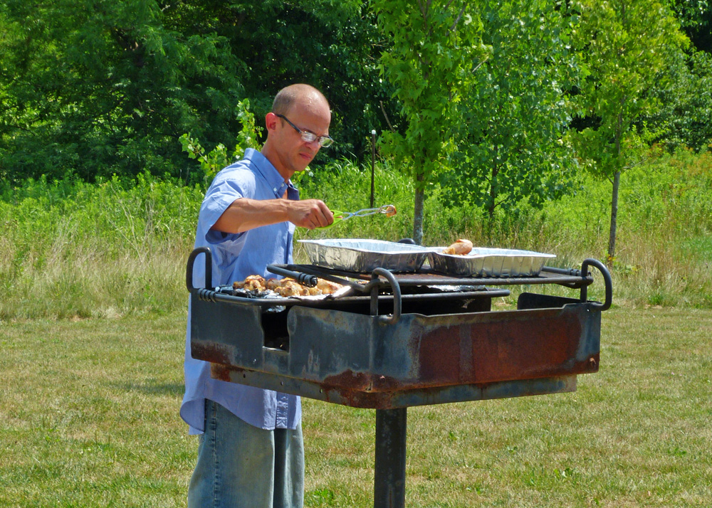  Visitor cooking on a park grill at the Glacier Knoll Picnic Area in Pickerington Ponds. 
