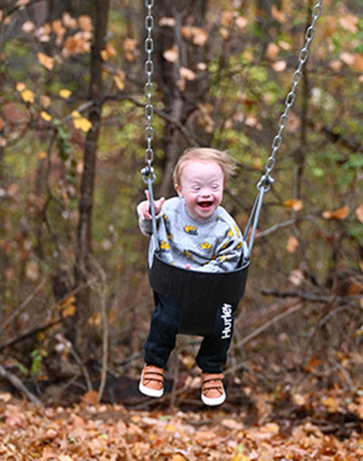 child swinging at the inclusive playground